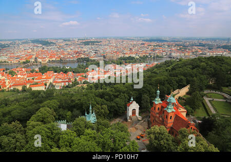 Panoramic aerial view of Prague, Czech Republic with St Lawrence Church near Petrin tower in foreground and Vltava river in background Stock Photo