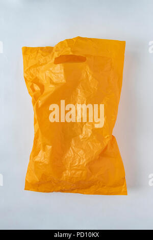 yellow plastic bag on a gray background Stock Photo
