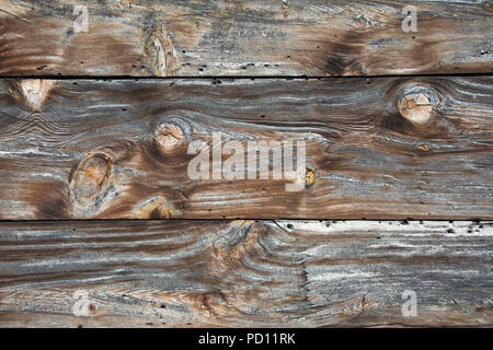 Closeup of weathered wall made from knotted wooden boards Stock Photo