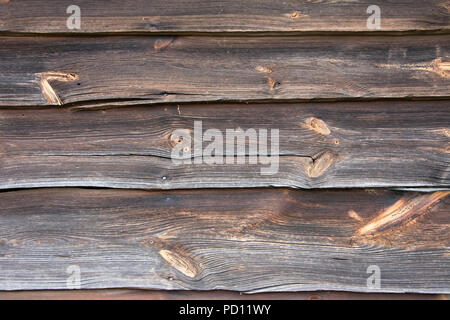 Closeup of weathered wall made from boards of wood with many knots Stock Photo