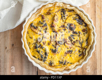 Mushroom quiche close up on wooden table - top view photo Stock Photo