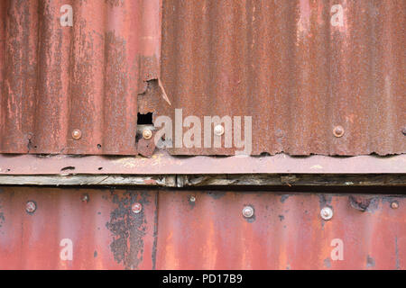Rusting Corrugated sheets on a farm building as a background Stock Photo