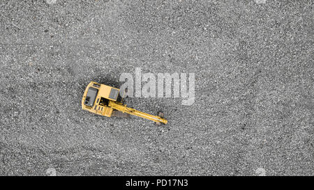 top view of excavator moving basaltic rocks Stock Photo
