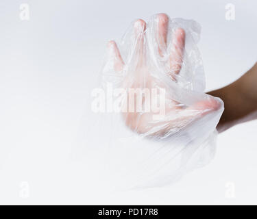 male hand in transparent plastic bag making stop sign Stock Photo