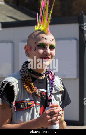 Female Punk with Liberty hair spikes; Jo Jo from Holland a colourful character at the resort Rebellion Punk Festival. Rebellion Festival, formerly Holidays in the Sun and the Wasted Festival is a British punk rock festival first held in 1996. Blackpool's annual display of coloured liberty dyed hair, denim clothing is back as every in August Blackpool, as the very best in Punk gather for the social event of the year. Stock Photo