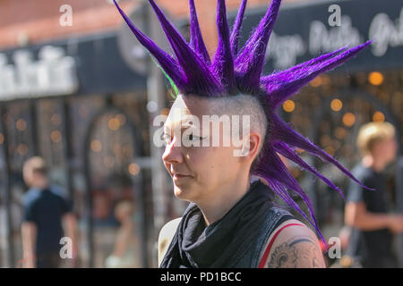 Blackpool, UK. 5 August 2018.  Colourful characters at the resort Rebellion Punk Festival. Rebellion Festival, formerly Holidays in the Sun and the Wasted Festival is a British punk rock festival first held in 1996. Blackpool's annual display of Liberty coloured,  long, thick, upright spikes of hair, is back as every August in Blackpool, the very best in Punk gather for the social event of the year.  Credit: MediaWorldImages/AlamyLiveNews Stock Photo