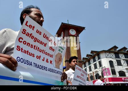 Srinagar, India. 5 August 2018. A member of Kashmir Traders and Manufactures Federation (KTMF) seen holding a placard during the protest.Life in Kashmir valley came to a standstill due to a complete shutdown called by the Joint Resistance Leadership (JRL) against the legal challenge in the Supreme Court on the validity of Article 35-A, which bars people from outside Jammu and Kashmir from acquiring any immovable property in the state. Traders staged a sit-down at the historic clock tower in Lal Chowk to protest the ''legal onslaught'' on the Article 35-A. Protestors carrying placards Credit: Z Stock Photo