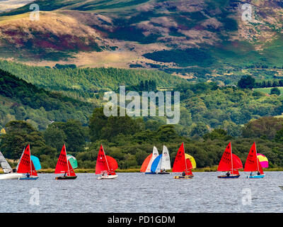 Bassenthwaite Lake, UK. 5th August, 2018. Good weather, but light winds, resulted in some early postponements on the second day of racing at Bassenthwaite Sailing Week. Hundreds of sail enthusiasts take part in the nine day event which is organised annually by Bassenthwaite Sailing Club in Cumbria. The backdrop of Skiddaw provides dramatic scenery for both sailors and spectators even if the good weather results in little wind power. This year the event runs from the 4th until the 12th of August. Photo Bailey-Cooper Photography/Alamy Live News Stock Photo