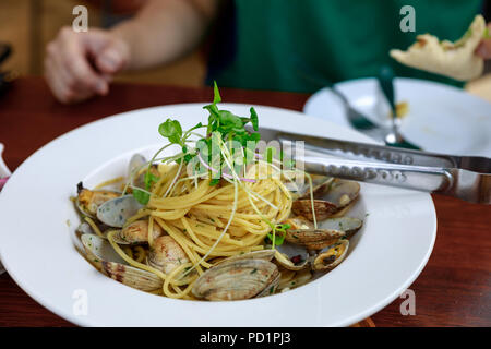 Italian cuisine, Spaghetti alle vongole on table Stock Photo