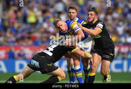 Leeds Rhinos' Brad Dwyer is tackled by Warrington Wolves' Declan Patton  and Dominic Crosby during the Ladbrokes Challenge Cup Semi Final match at the Macron Stadium, Bolton. PRESS ASSOCIATION Photo. Picture date: Sunday August 5, 2018. See PA story RUGBYL Warrington. Photo credit should read: Dave Howarth/PA Wire. RESTRICTIONS: Editorial use only. No commercial use. No false commercial association. No video emulation. No manipulation of images. Stock Photo