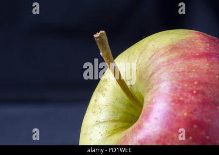 Closeup of ripe red and yellow apple on black background Stock Photo