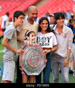 Manchester City manager Josep Guardiola with the Community Shield trophy and family wife Cristina Serra and children Valentina Guardiola, Maria Guardiola and Marius Guardiola after the Community Shield match at Wembley Stadium, London. Stock Photo