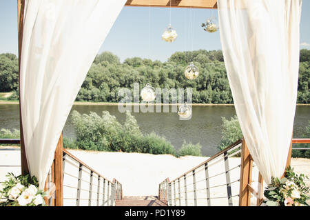 wedding arch on the river bank Stock Photo