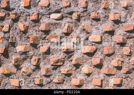 Ancient red bricks stone wall texture background Stock Photo