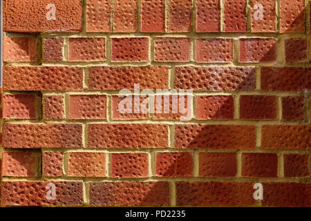 Modern tall brick wall in English bond pattern. Minimalist frontal composition. Authentic background for design and building services.. Stock Photo