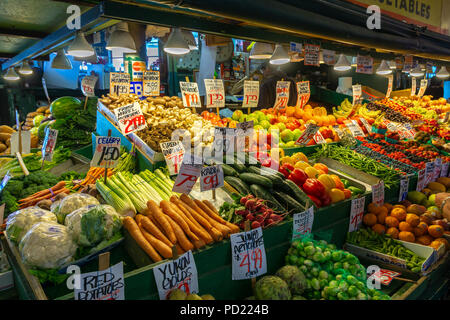 Fresh vegetables veggies fruits food displayed on stall stand for sale with prices inside Pike Place Market, Seattle, WA, USA. Stock Photo