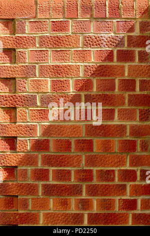 Modern tall brick wall in English bond pattern. Minimalist frontal composition. Authentic background for building and graphic design. Stock Photo