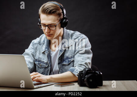 young good-looking man is concentrated on working in the Internet. closeup side view shot Stock Photo