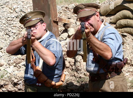 Churston Devon, England: Two First World War soldiers re-enact trench life as they aim rifles at the photographer at the annual Torbay Steam Fair. Stock Photo