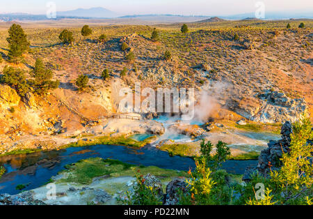 Hot springs send up steam in early morning at Hot Creek Geological Site near Mammoth Lakes, California. Stock Photo