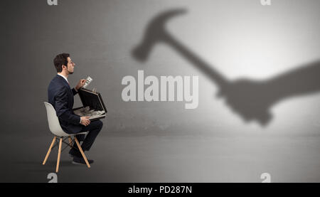Small businessman staying and offering stuffs for an armed shadow hand  Stock Photo