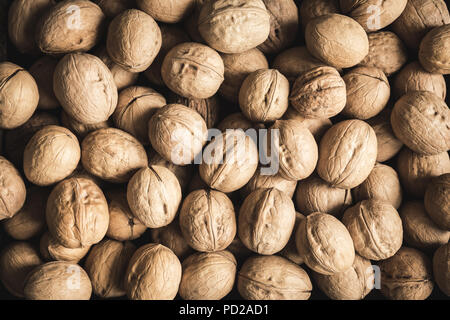 Organic Walnuts as background, top view. Seasonal harvest of walnuts. Stock Photo