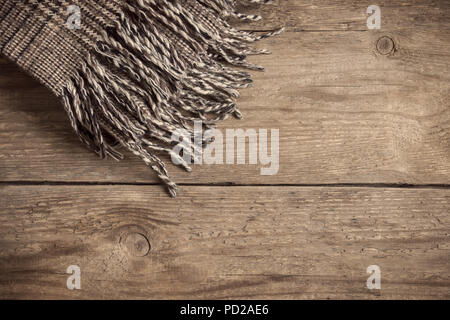 Brown checkered plaid on wooden background. Stock Photo