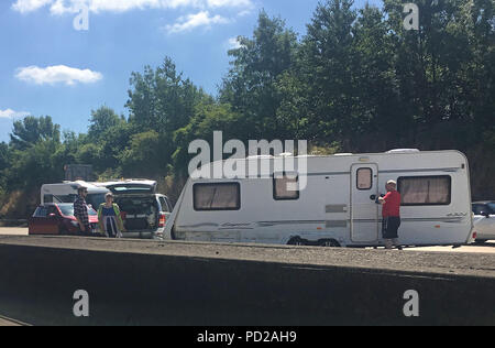 A jack knifed caravan on the M25 between junctions 8 and 9 which closed 3 lanes of the motorway. Stock Photo