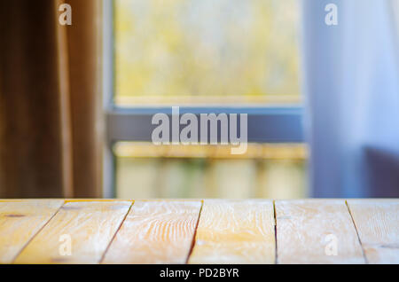 Empty Wooden Table in Front of Blurred Background of Window Curtains in Living Room. Mock Up for Display of Product. Blank for Your Layout Stock Photo