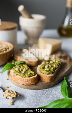 Italian pesto bruschetta on cutting board. Closeup view, selective focus Stock Photo