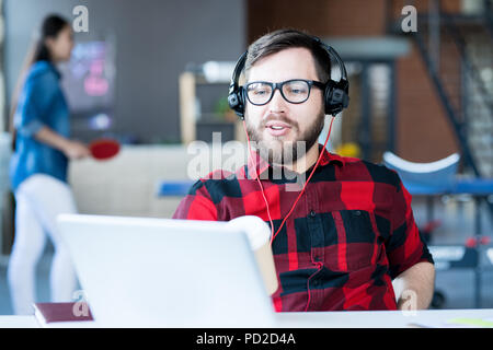 Modern Bearded Man Video chatting  in IT Office Stock Photo