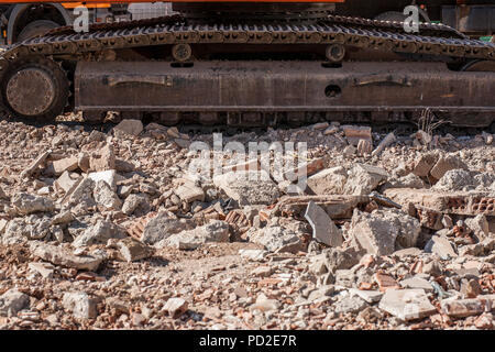 Tracks of excavator over loads of rubble debris. Construction site Stock Photo