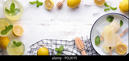 Glasses of lemon juice on wooden table Stock Photo