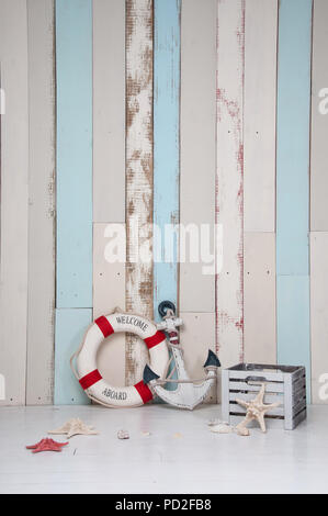 Composition on a marine theme with an anchor and life buoy, seashells and starfish on a wooden background Stock Photo
