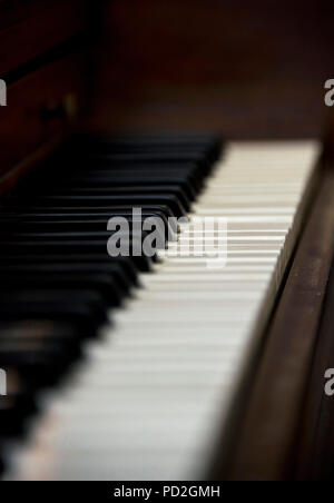 Black and white keys on old wooden piano Stock Photo