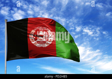 National flag of Afghanistan on a flagpole in front of blue sky. Stock Photo