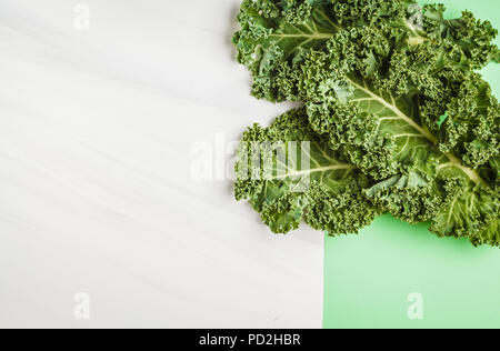 Leaves of kale on a white green background. Top view, copy space. Healthy food background, clean eating concept. Stock Photo