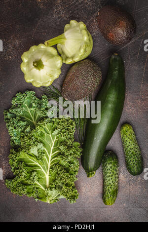 Assortment of green vegetables on dark background, top view. Fruits and vegetables containing chlorophyll. Stock Photo