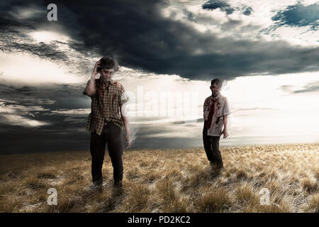 Spooky zombies on the grassland with dramatic sky background. Halloween concept Stock Photo