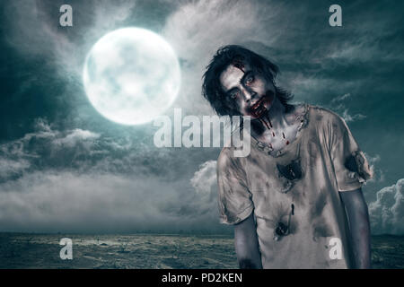 Creepy zombie man with blood on his mouth over moonlight background Stock Photo