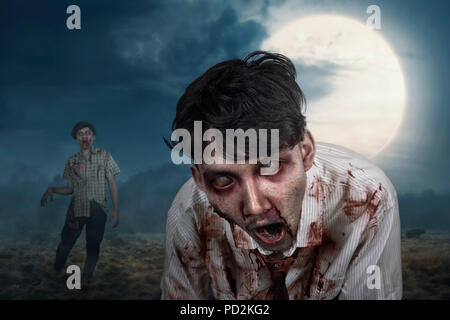 Bloody zombies hanging around on the midnight with full moon background Stock Photo