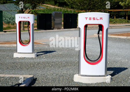 Topsham, Devon, UK. Tesla supercharger station located in Darts Farm Stock Photo
