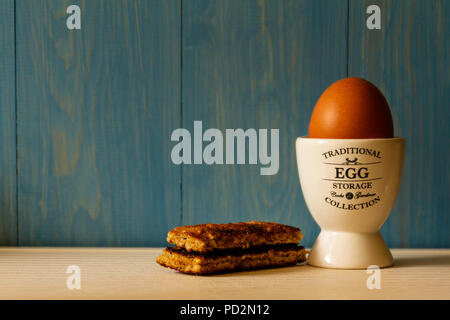 Boiled egg in an egg cup with toast soldiers Stock Photo