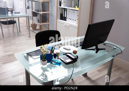 Interior Of Modern Office With Computer On Glass Desk Stock Photo