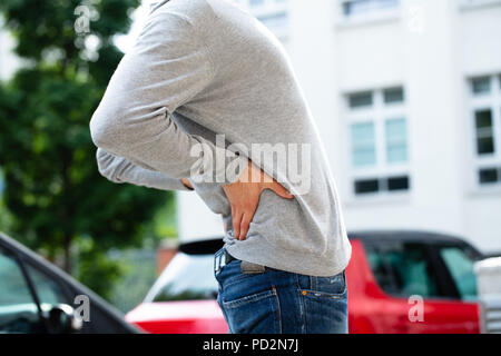 Mid Section View Of A Man Suffering From Back Pain Stock Photo