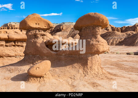 Stunning Hoodoos sandstone formations in famous Goblin Valley State Park on a beautiful sunny day with blue sky and clouds in summer, Utah, USA Stock Photo