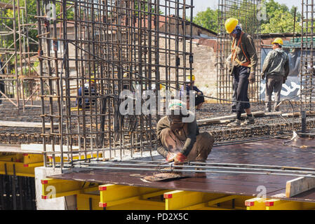 workers at the construction site produce welding work to fill the foundation with concrete. candid, real people Stock Photo