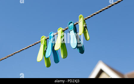 coloured clothes pegs in English garden Stock Photo