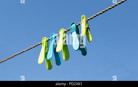 coloured clothes pegs in English garden Stock Photo