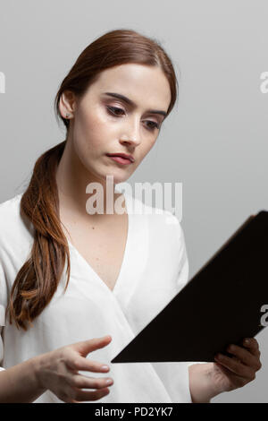 Woman reading documents Stock Photo